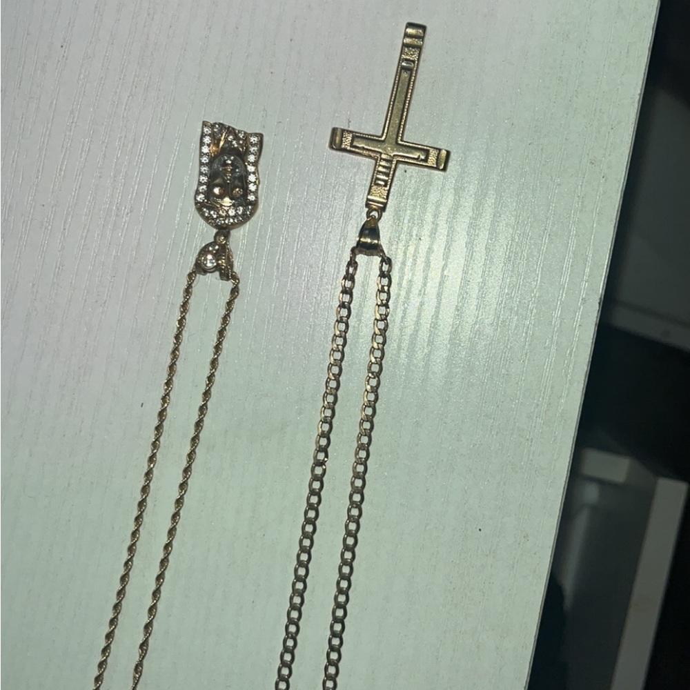 2 used 10k gold chains with pendants